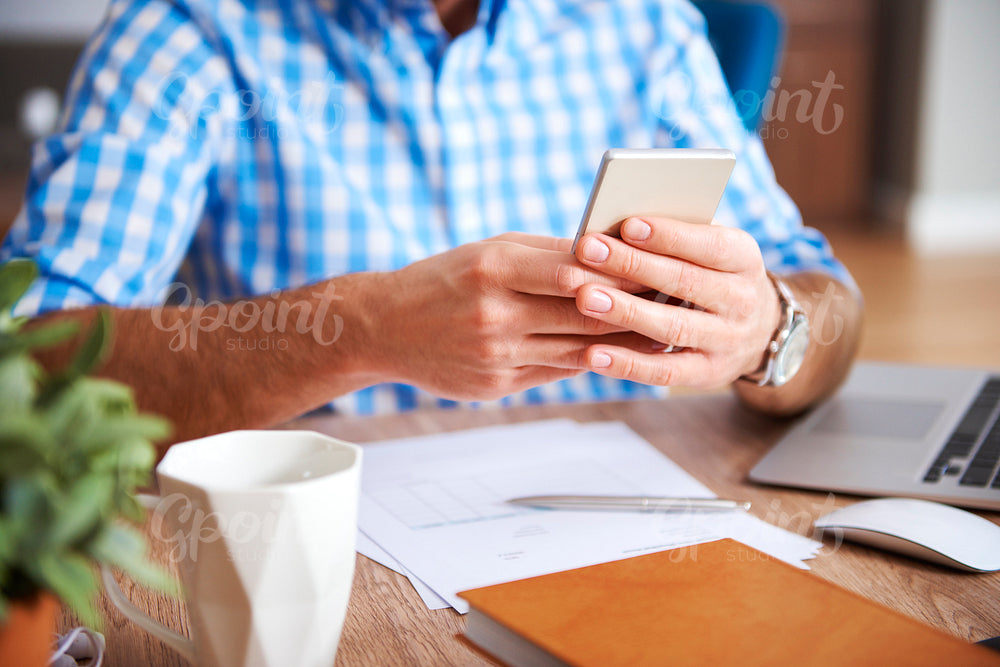 Close up of man's hands using mobile phone