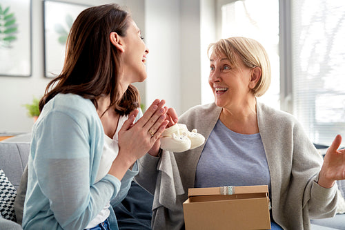 Excited woman informs mom that she will become a grandmother