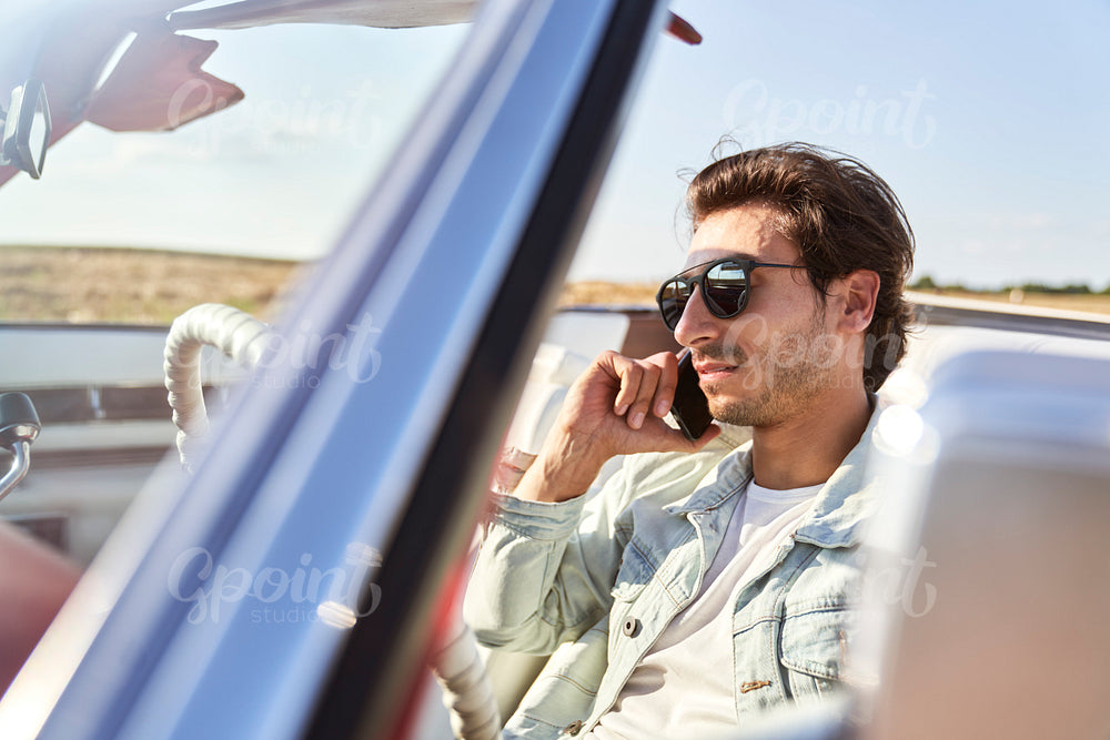 Close up of man talking on the phone in a car