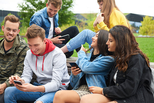 Group of young people using mobile phone