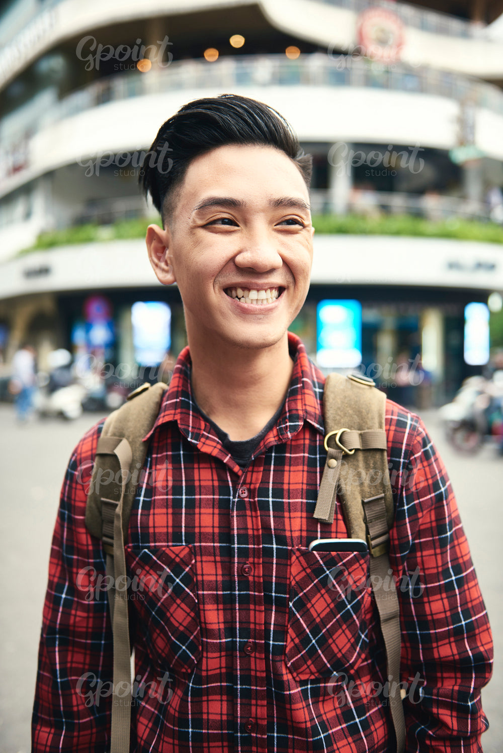 Young Asian man smiling and looking away