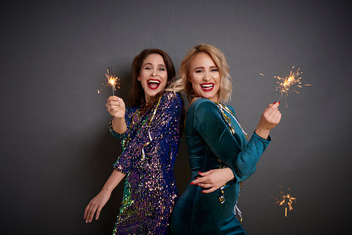 Two glamorous women having fun with sparklers