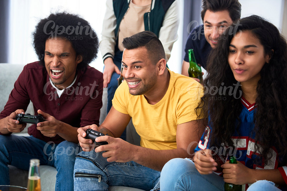 Friends having fun while playing a game console