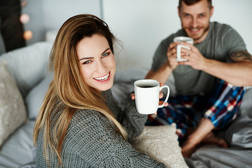 Heterosexual couple with coffee in bed