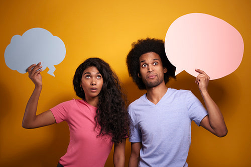 Shocked Afroamerican couple with speech bubbles
