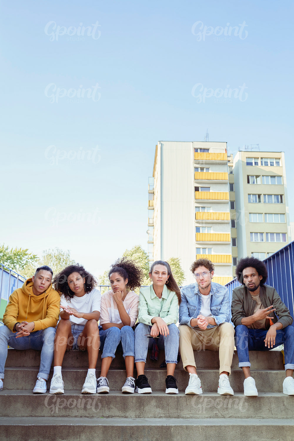 Portrait of young group of friends sitting on the stairs