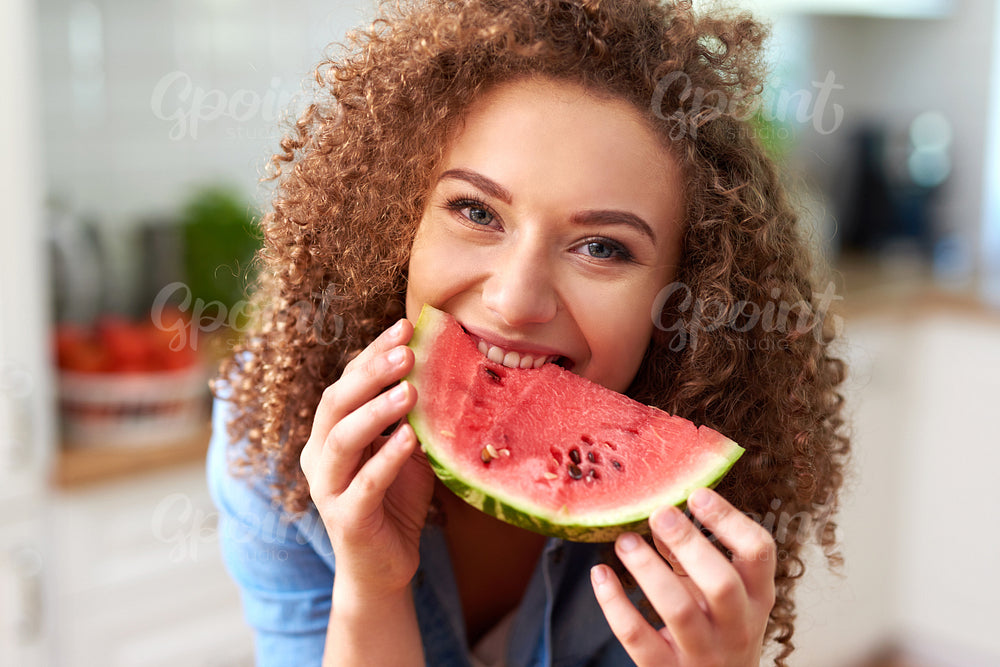 Beautiful woman eating a watermelon