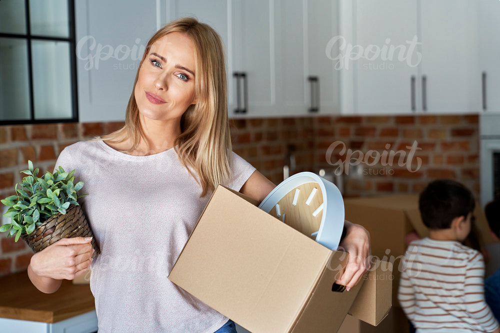Portrait of woman with a cardboard box during moving