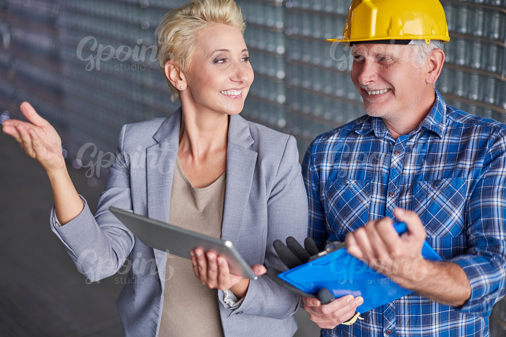 Manager with manual worker in warehouse