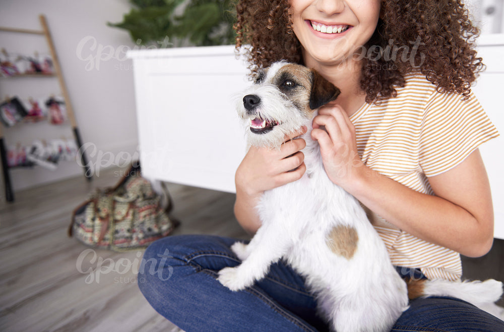 Young woman stroking her dog
