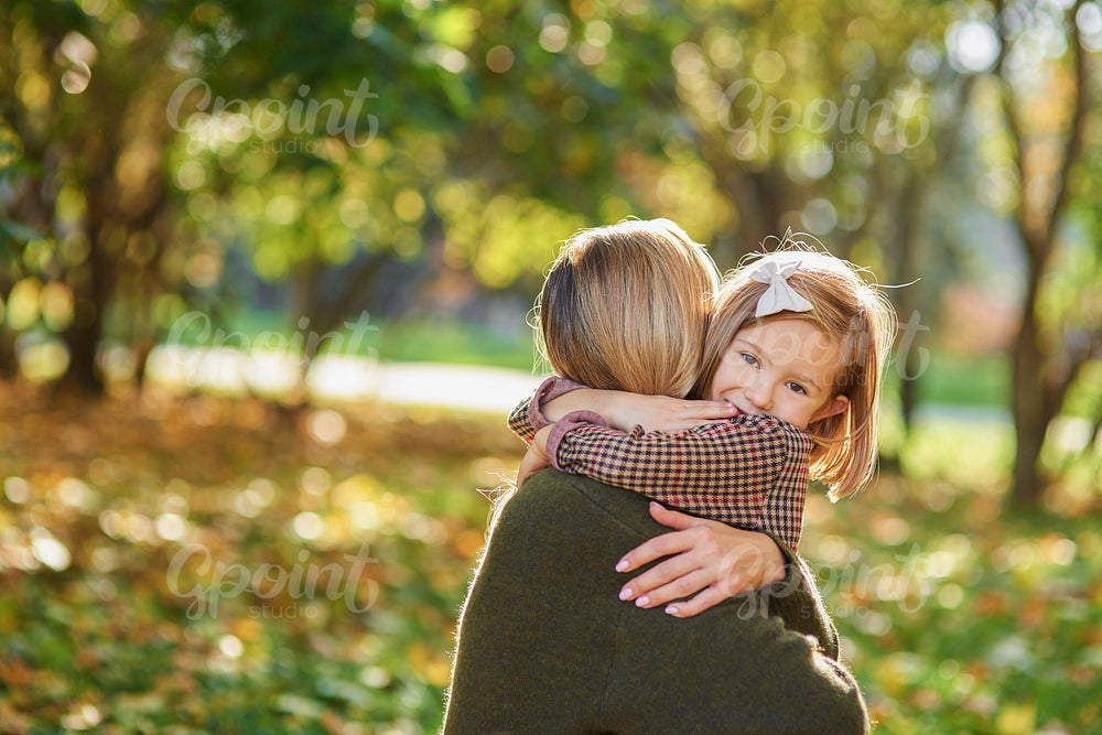 Portrait of little girl embracing her mommy