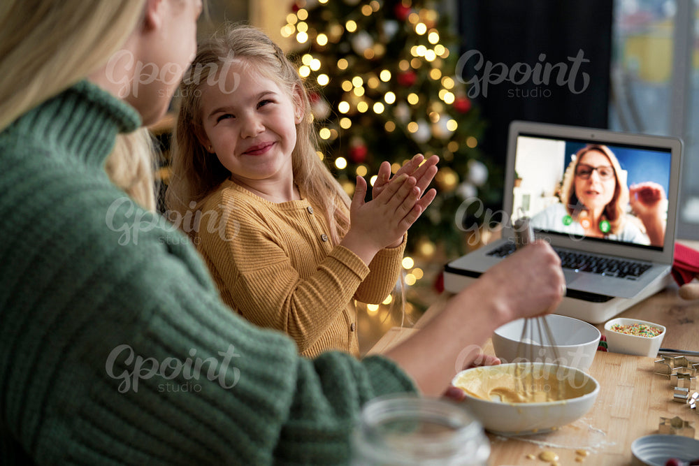 Grandmother advising on how to make cookies during a video conference