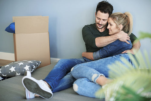 Couple relaxing while moving house