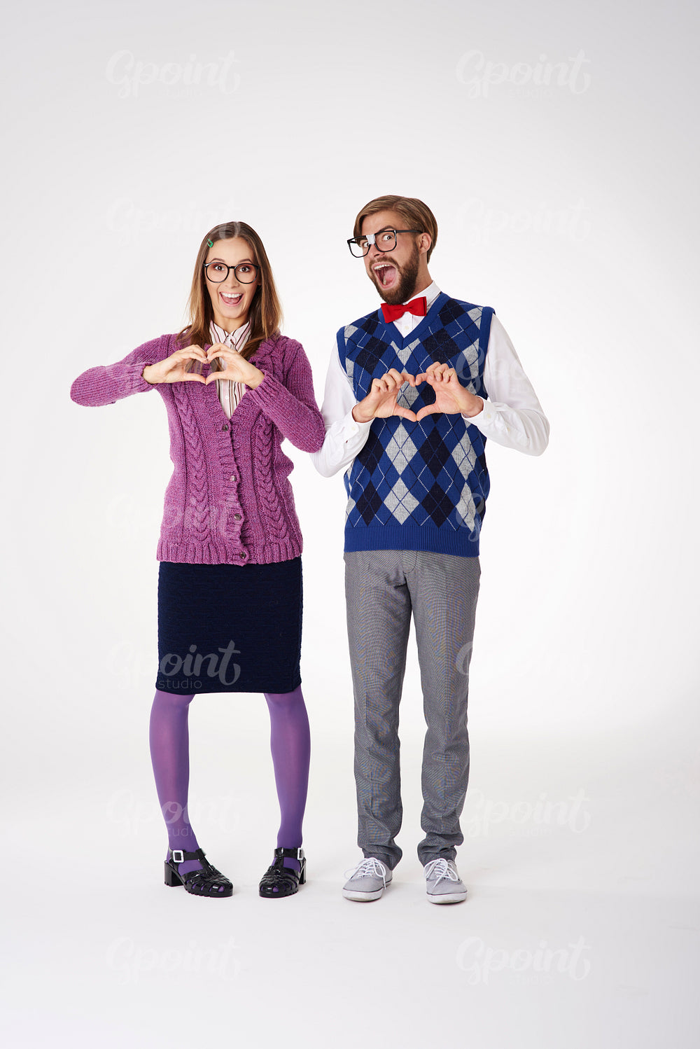 Couple forming heart shape by hands