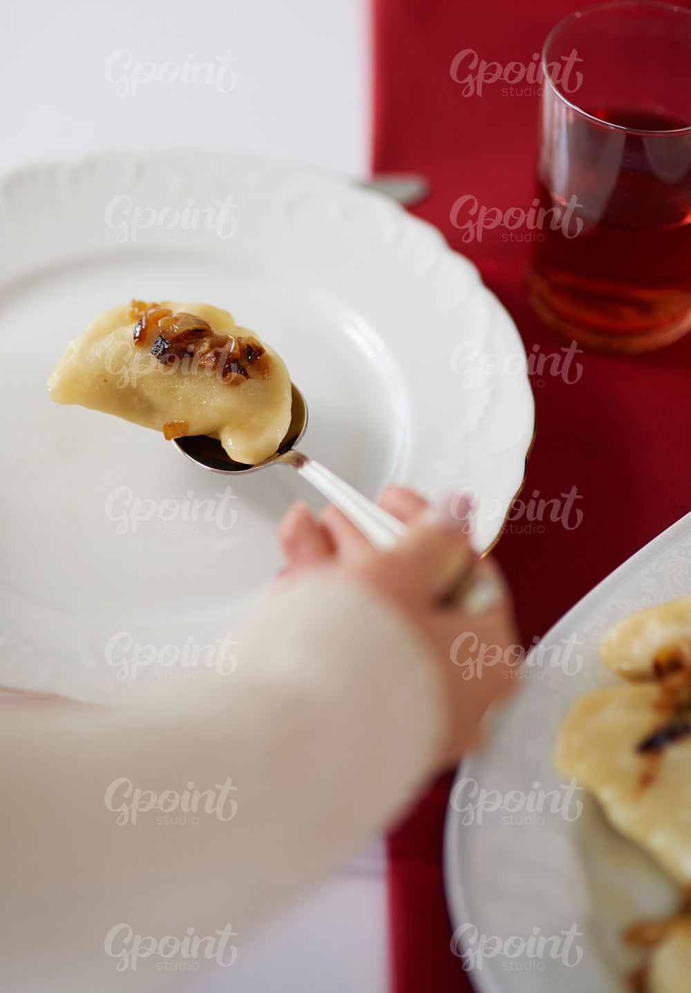 Woman serving dumplings on the plate