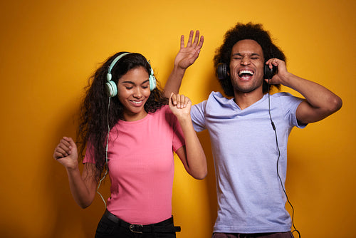 Two cheerful African people in headphones