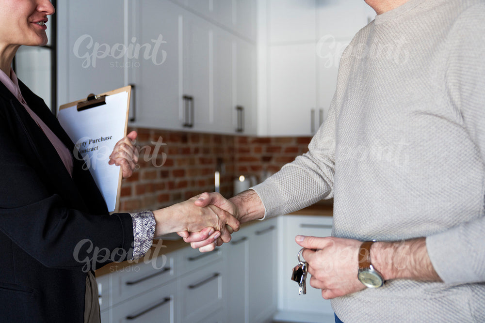Close up of estate agent in the handshake of a customer