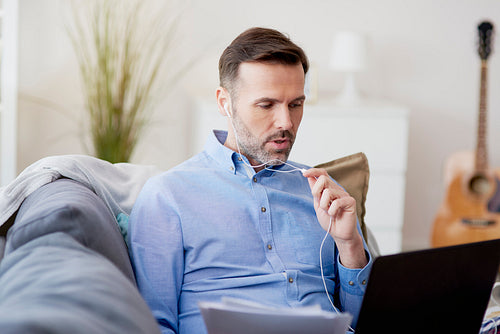Man having a mobile conversation during home office