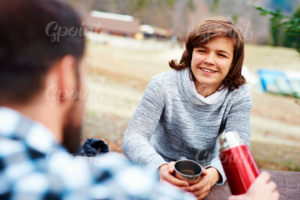 Portrait of teenage hiker drinking tea