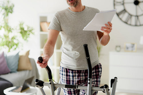 Man doing exercises and checking documents