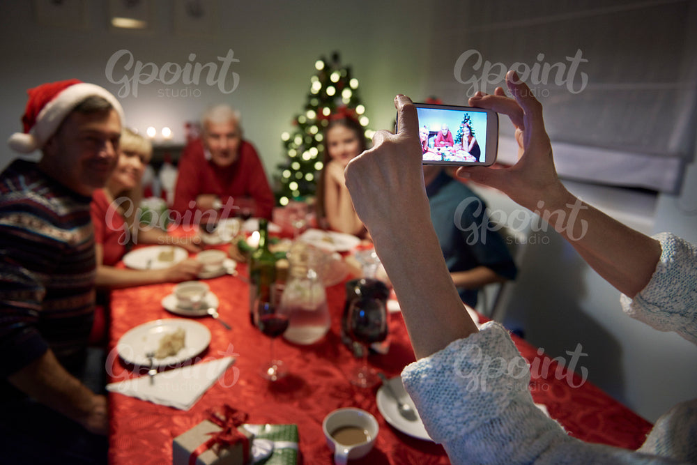 Unrecognizable person taking photography of the family