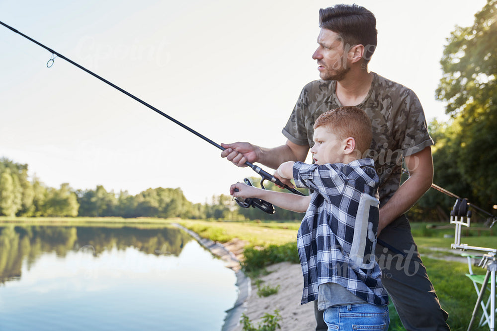 Father teaching son how to fish