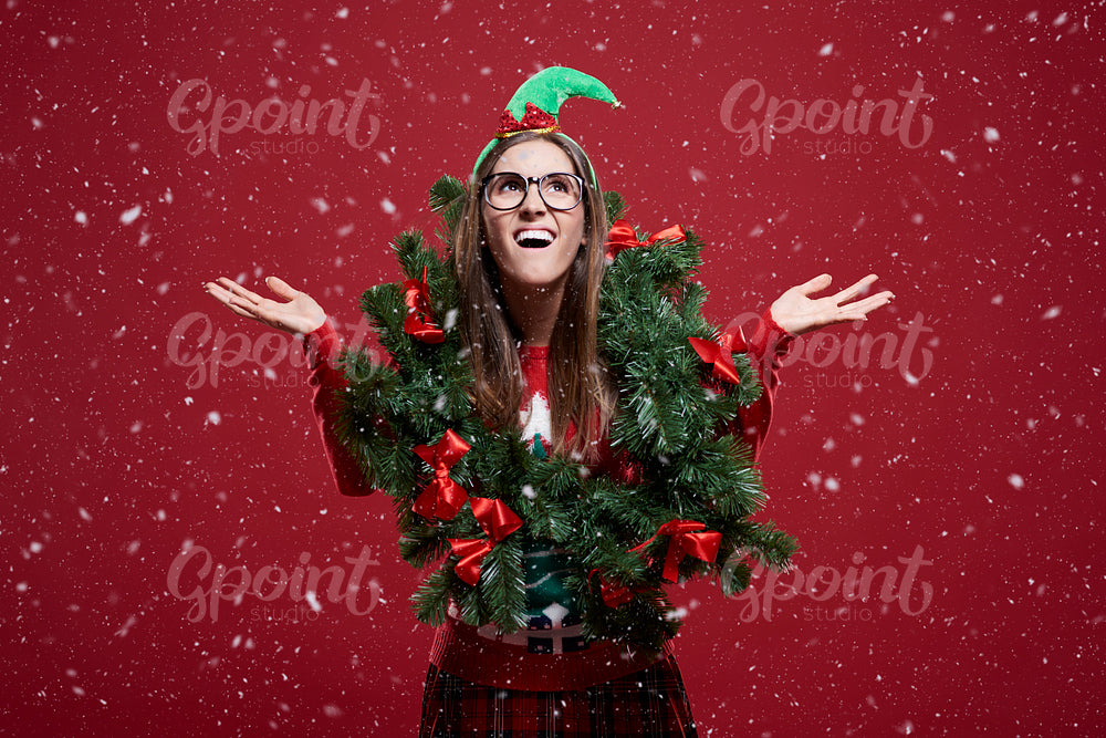 Funny woman with Christmas garland in the snow