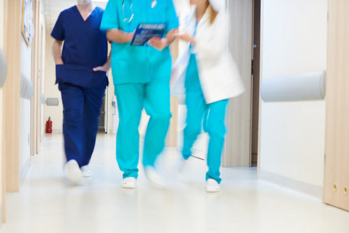 Doctors walking through corridor in hospital
