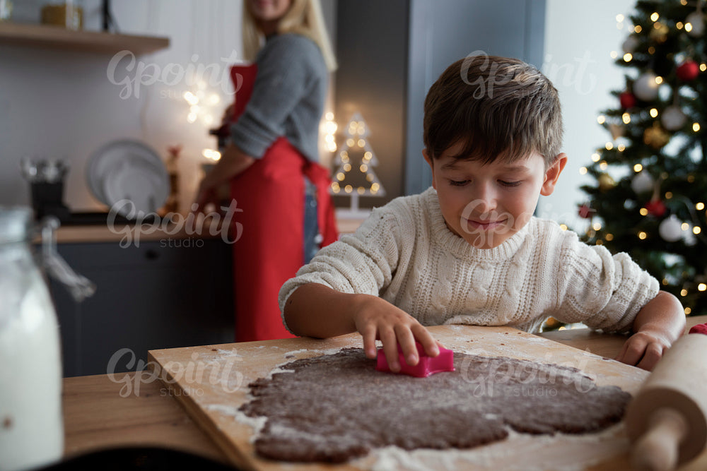Boy crafting ginger bread cookies
