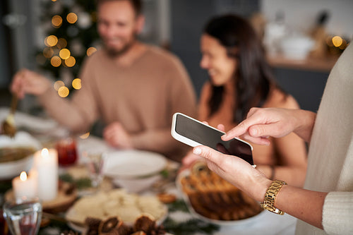 Close up of woman using mobile phone at Christmas Eve