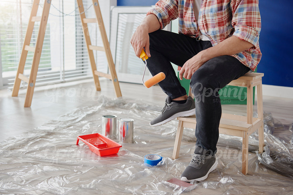 Unrecognizable man ready to paint a room