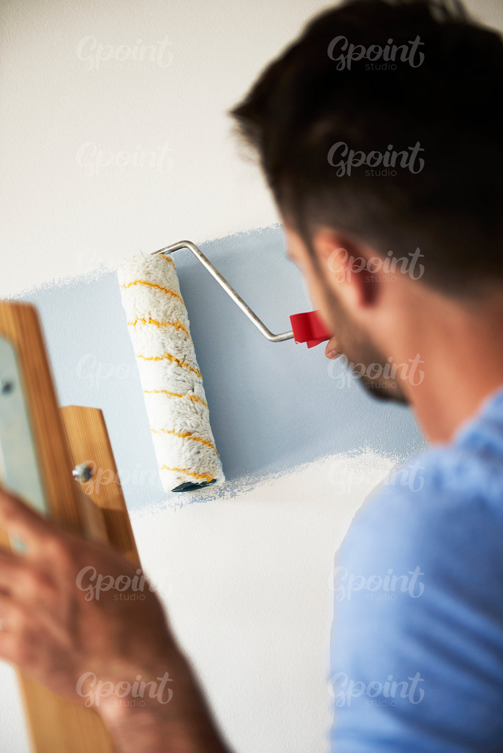 Close up of man painting his room