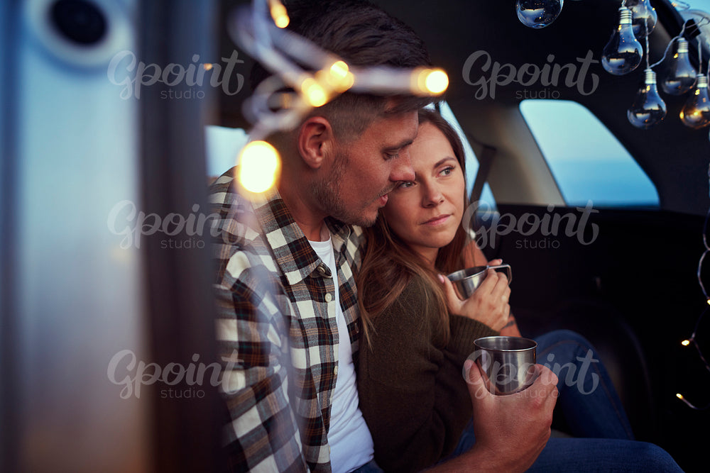Close up loving couple embracing and sitting in car.