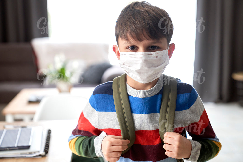 Close up of portrait schoolboy in protective face mask