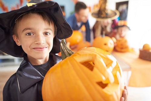 Little boy with big Halloween pumpkin