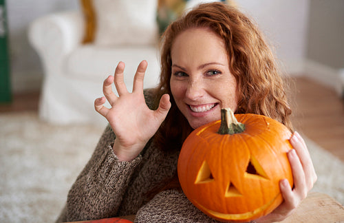Portrait of woman holding halloween pumpkin