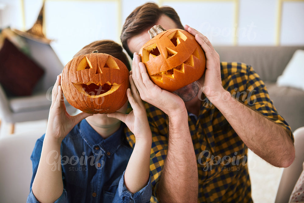 Father and boy with scary Halloween pumpkin
