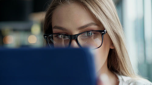 Close up of focused woman using tablet in the office
