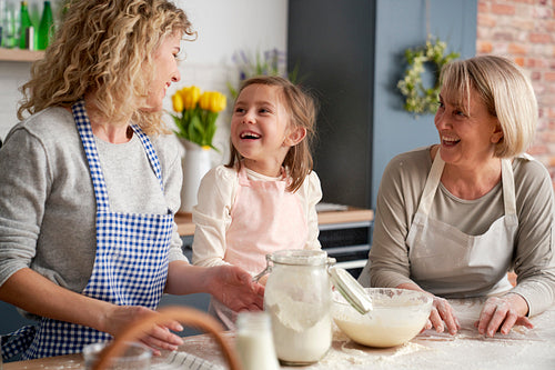Happy three generations of women during baking in the kitchen