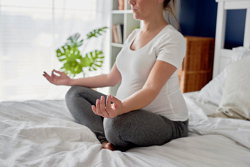 Woman in advanced pregnancy practicing meditation