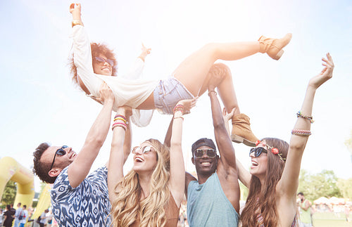 Excited woman crowd surfing at music festival