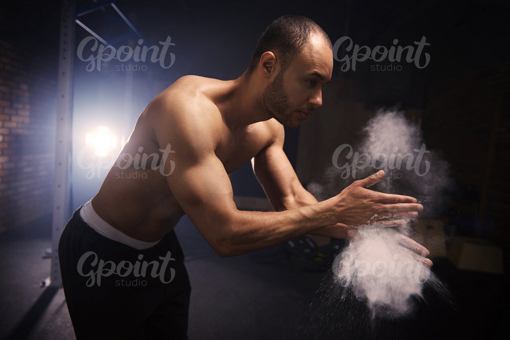 Fit man applying chalk on his hands