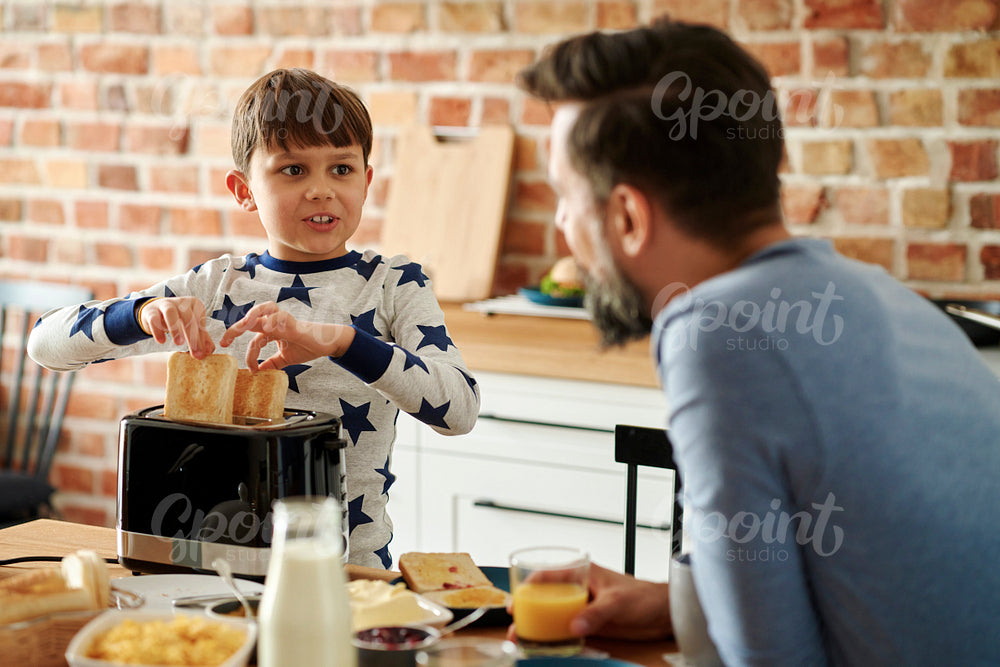 Father and son having breakfast in the morning