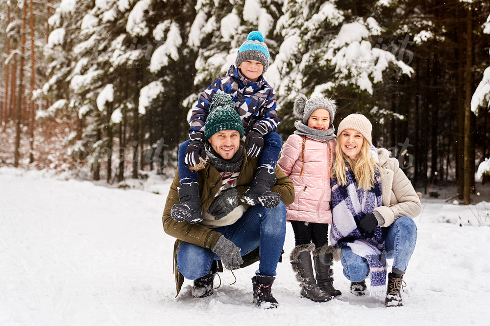 Front view portrait of family a snowy forest