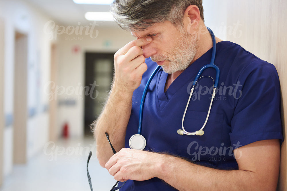 Mature doctor tired after long day
