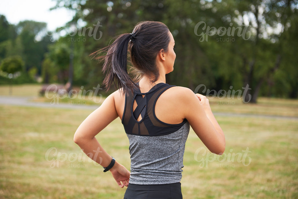 Rear view of young woman running in the park