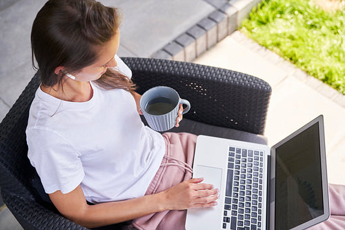 Busy woman working on laptop outdoors