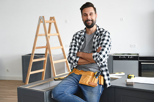 Portrait of smiling carpenter on the workplace