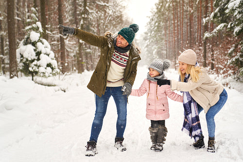 Family spending time in forest during the winter