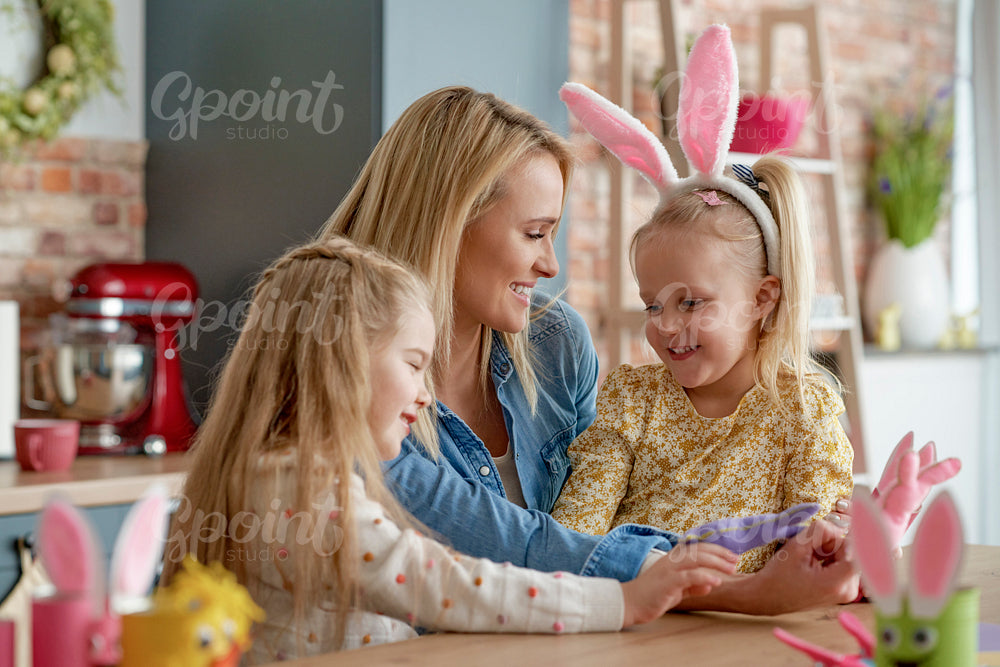 Mom and two small daughters with Easter accessories